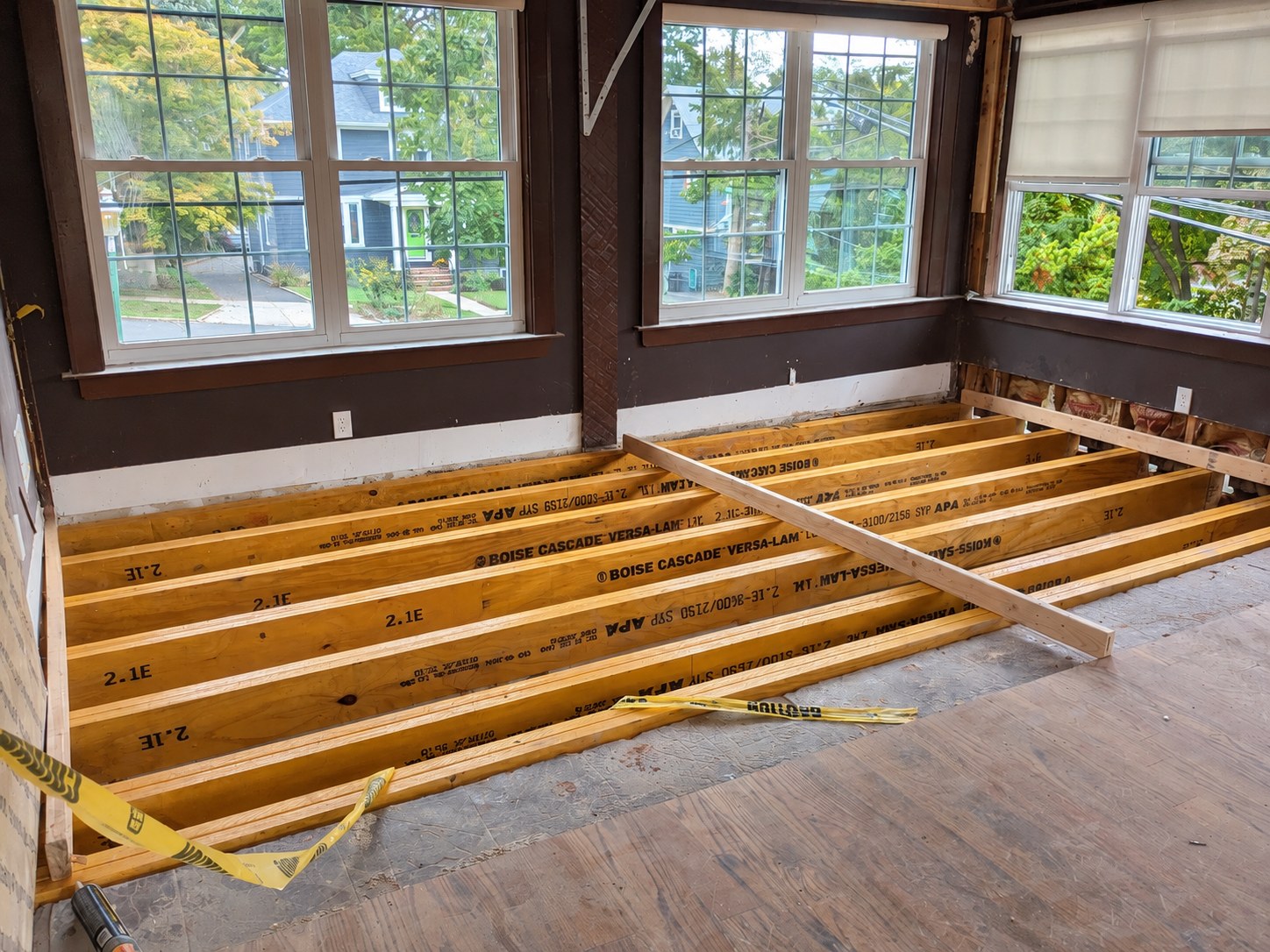 Engineered wood floor framing exposed beneath room windows