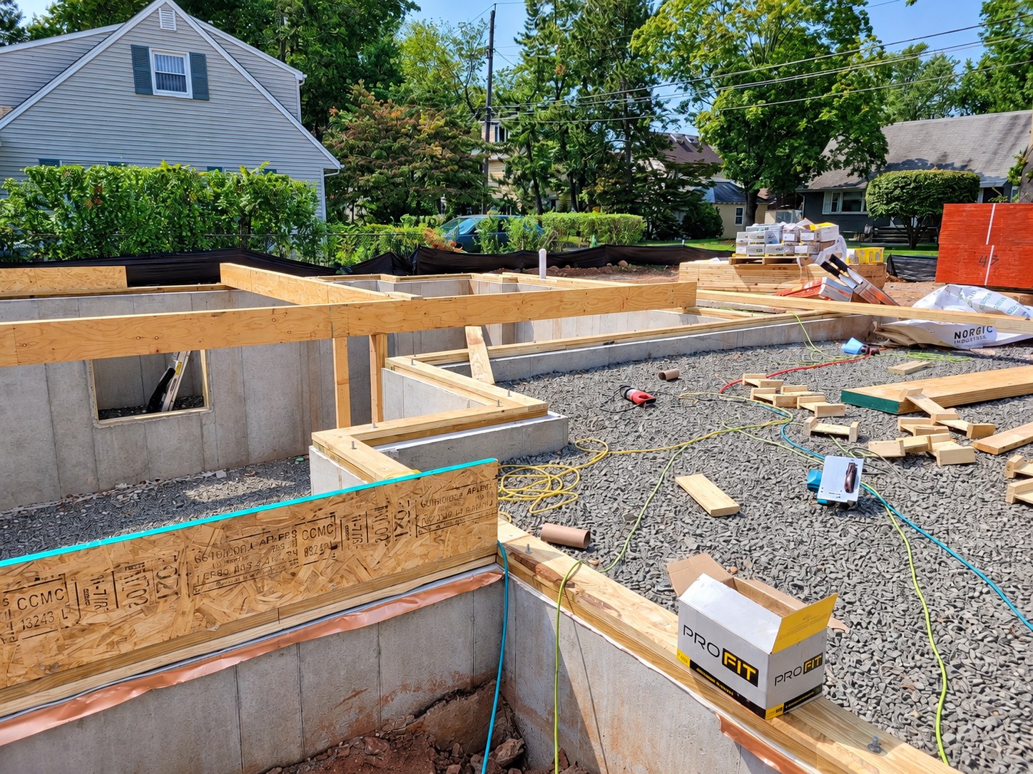 Wood framing above exposed concrete foundation walls